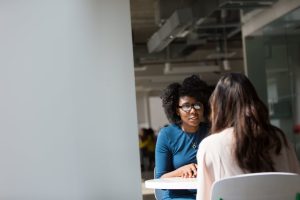 Business meeting with two women sat around a table