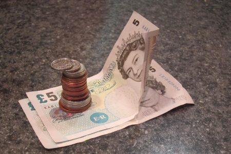 stack-of-coins-on-note